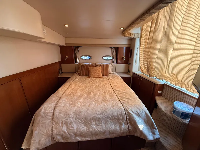 Slide: The Image of Luxurious bedroom interior of 2005 Meridian 459 Motoryacht with elegant bedding and natural light. - 48