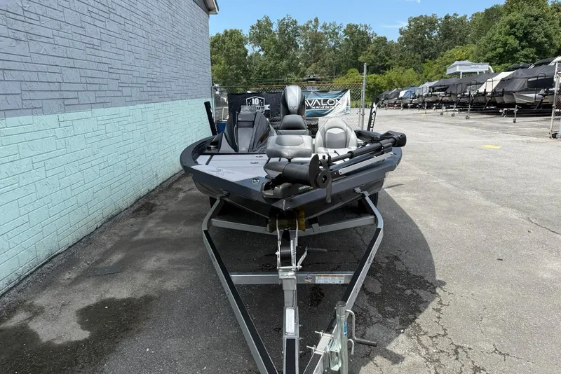 Slide: The Image of 2023 Xpress H17 boat on trailer, parked outdoors near a brick wall. - 3