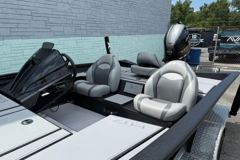 Slide: The Image of 2023 Xpress H17 boat interior with gray seats and steering console. - 5