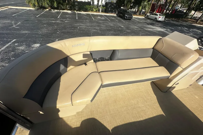Slide: The Image of Luxurious seating on 2022 Harris Cruiser 230 boat, featuring beige and gray upholstery. - 10