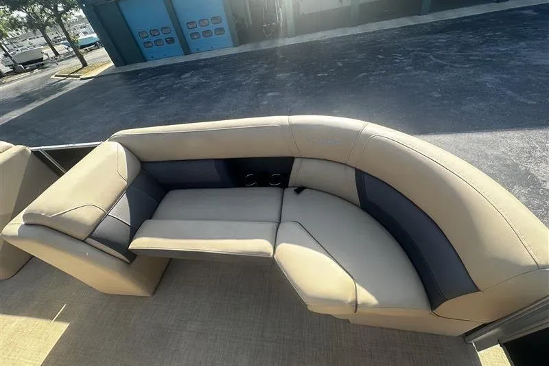 Slide: The Image of 2022 Harris Cruiser 230 boat interior with beige and gray seating. - 11