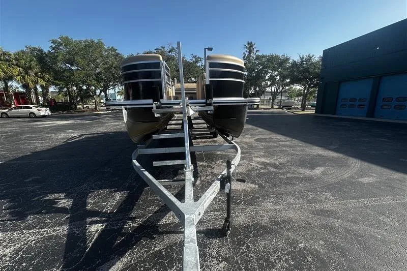 Slide: The Image of 2022 Harris Cruiser 230 pontoon boat on trailer in parking lot. - 3