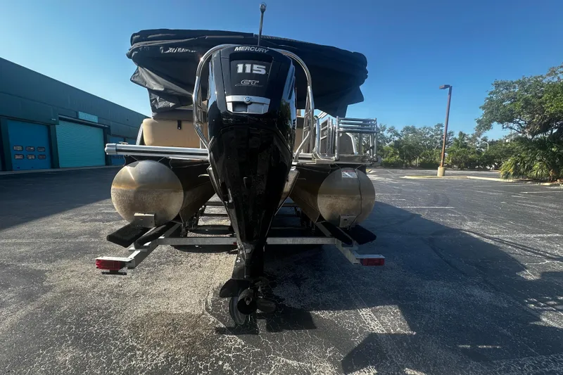 Slide: The Image of 2022 Harris Cruiser 230 pontoon boat with Mercury 115 engine in parking lot. - 4