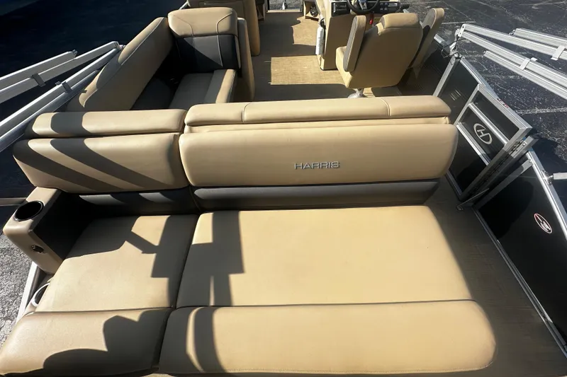 Slide: The Image of 2022 Harris Cruiser 230 pontoon boat with beige seating and modern interior design. - 5
