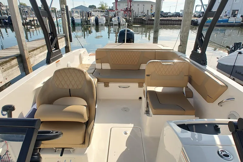 Slide: The Image of 2024 Bayliner VR6 Bowrider OB with tan seating, docked at a marina. - 10