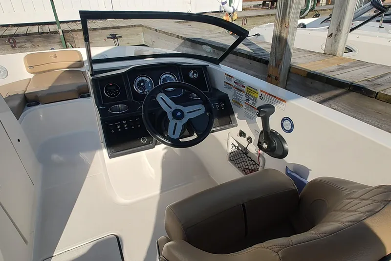 Slide: The Image of 2024 Bayliner VR6 Bowrider OB cockpit with steering wheel and control panel. - 11
