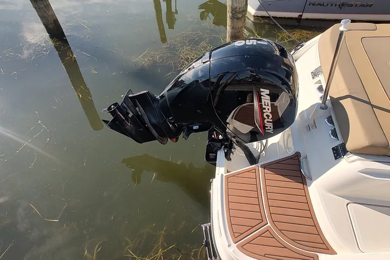 Slide: The Image of 2024 Bayliner VR6 Bowrider OB with Mercury outboard motor on calm water. - 4