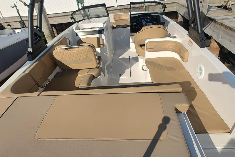 Slide: The Image of 2024 Bayliner VR6 Bowrider OB with tan seating and spacious interior design. - 7