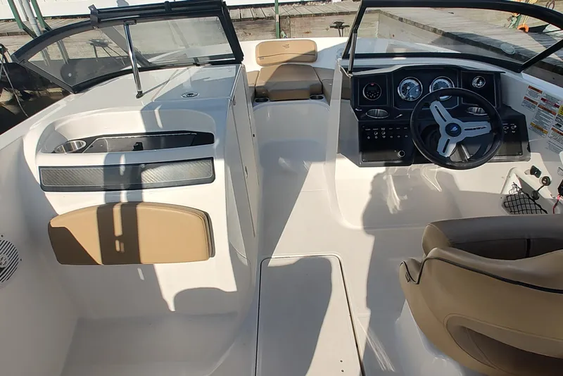 Slide: The Image of 2024 Bayliner VR6 Bowrider OB interior with steering wheel and seating area. - 8