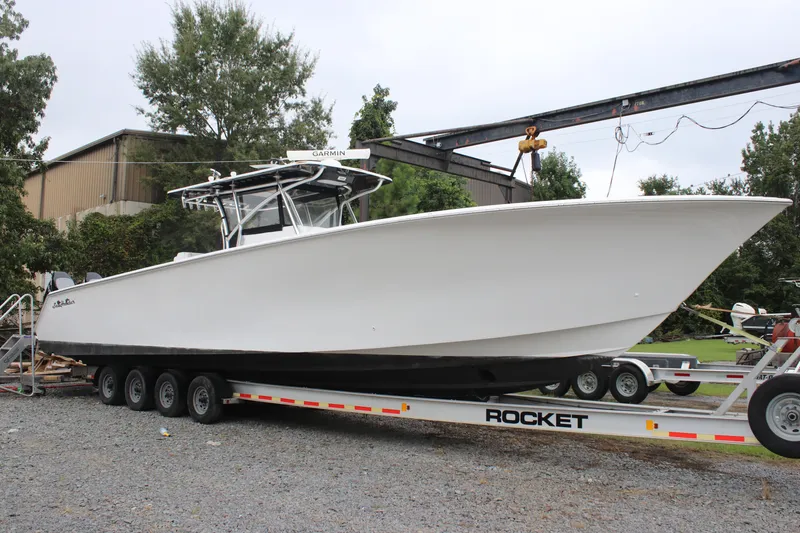 Slide: The Image of 2015 SeaHunter 45 Tournament boat on trailer, parked outdoors. - 13