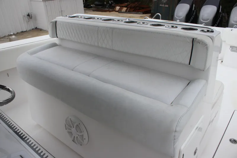 Slide: The Image of White cushioned seating on 2015 SeaHunter 45 Tournament boat with rod holders and speaker. - 15
