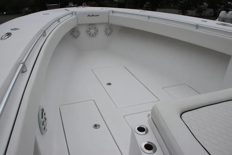 Slide: The Image of 2015 SeaHunter 45 Tournament boat interior with white seating and storage compartments. - 16