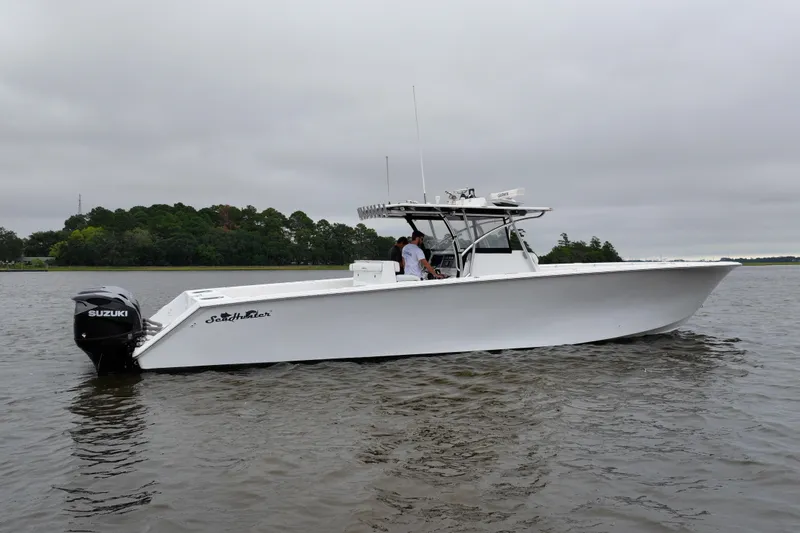 Slide: The Image of 2015 SeaHunter 45 Tournament boat on water, featuring Suzuki outboard engines. - 2