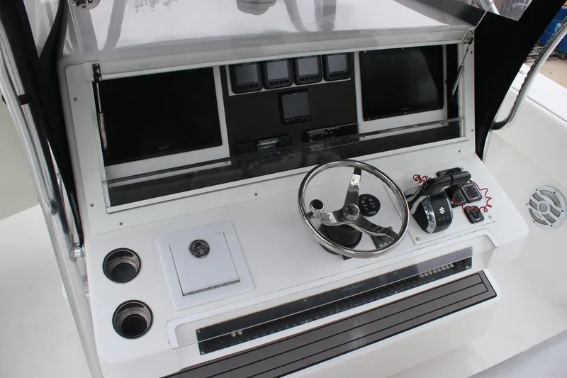 Slide: The Image of Control panel of 2015 SeaHunter 45 Tournament boat with steering wheel and electronics. - 24