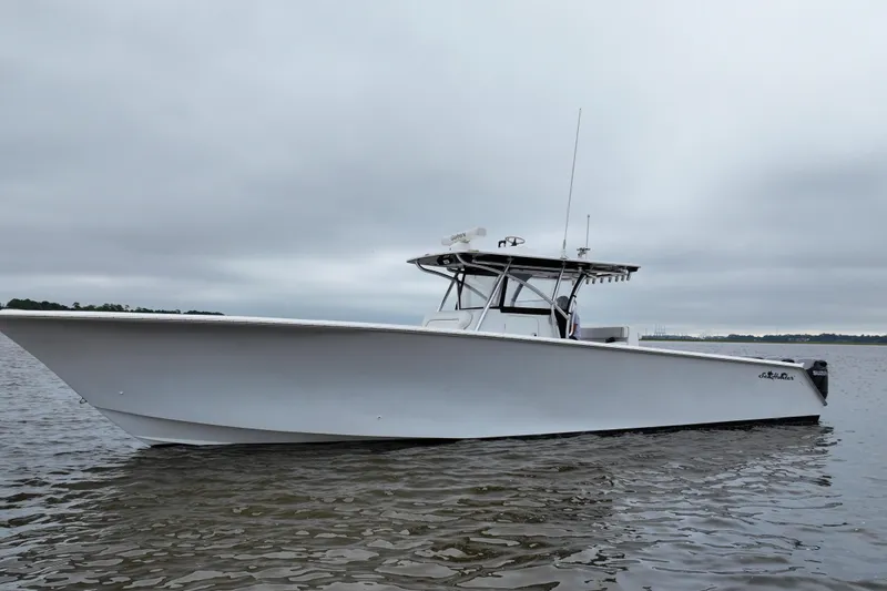 Slide: The Image of 2015 SeaHunter 45 Tournament boat on calm water under cloudy sky. - 5