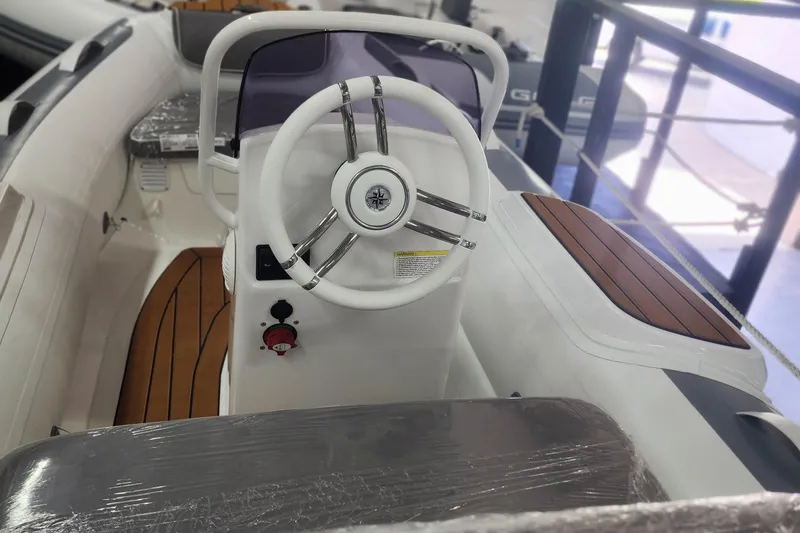 Slide: The Image of 2024 Gala A330L inflatable boat in a showroom, featuring sleek design and modern seating. - 6