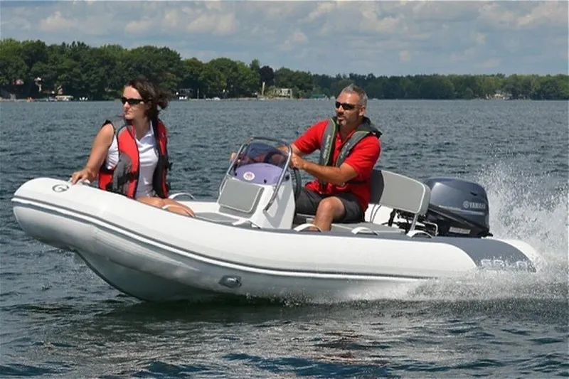 Slide: The Image of 2024 Gala A330HL boat with Yamaha 25HP engine on a lake, two people onboard. - 7