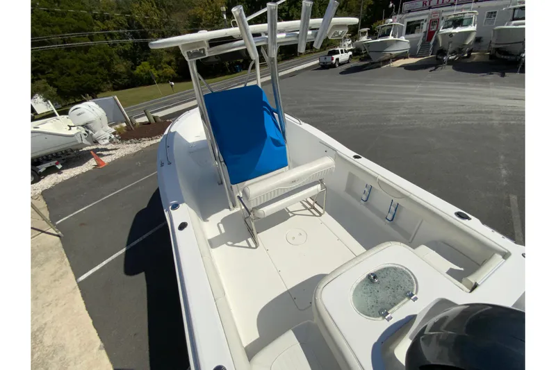 Slide: The Image of 2008 Sea Hunt Triton 220 boat with blue seating, parked in a marina lot. - 14