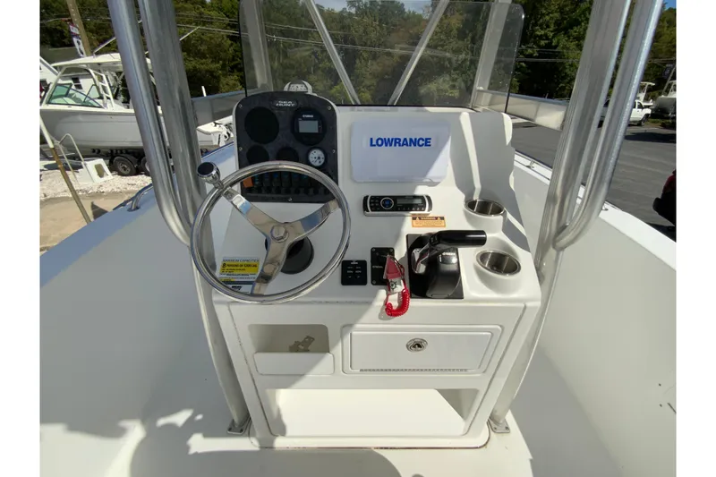Slide: The Image of 2008 Sea Hunt Triton 220 boat console with steering wheel and navigation equipment. - 16