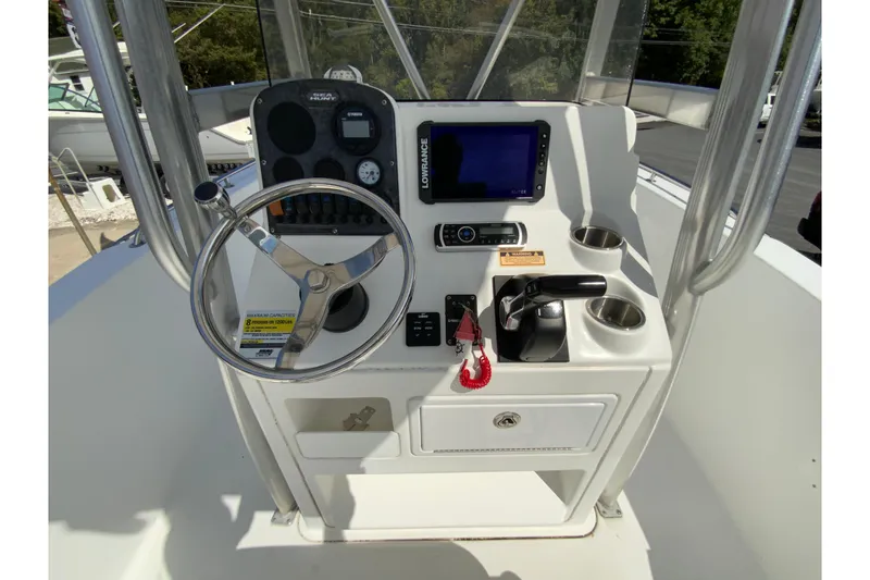 Slide: The Image of 2008 Sea Hunt Triton 220 boat console with steering wheel and navigation equipment. - 17
