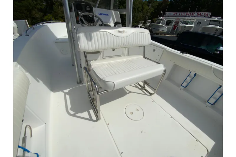 Slide: The Image of 2008 Sea Hunt Triton 220 boat interior with white seating and steering console. - 22