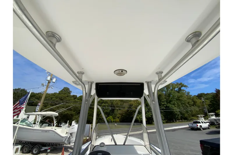 Slide: The Image of 2008 Sea Hunt Triton 220 boat with T-top and surrounding marina view. - 23