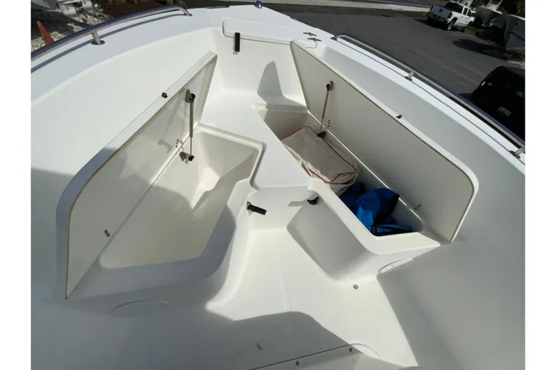 Slide: The Image of 2008 Sea Hunt Triton 220 boat interior with open storage compartments. - 26
