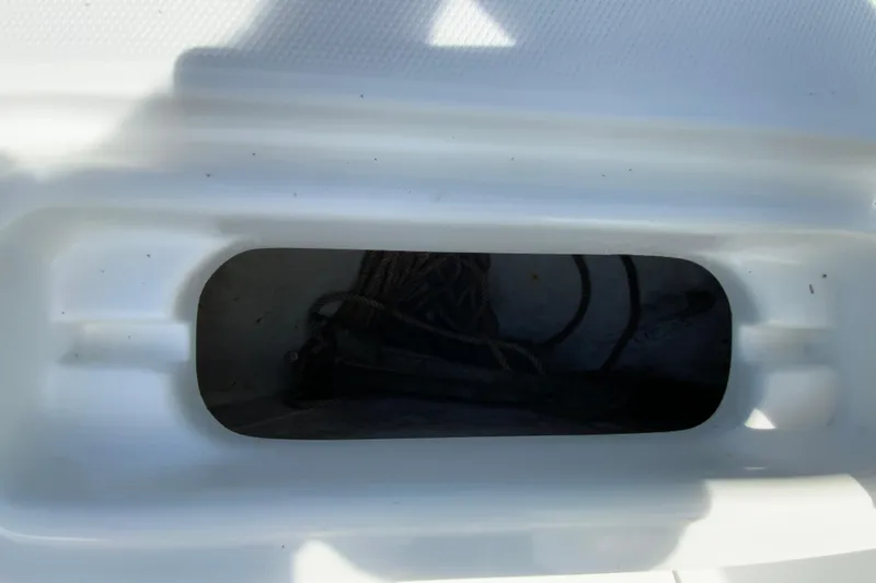 Slide: The Image of Storage compartment on a 2008 Sea Hunt Triton 220 boat, featuring ropes inside. - 28