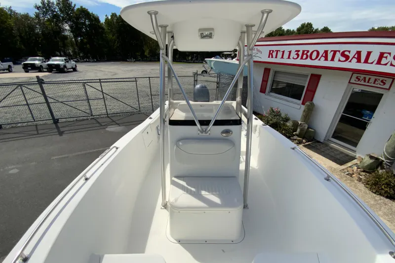 Slide: The Image of 2008 Sea Hunt Triton 220 boat at dealership, featuring center console and T-top. - 29