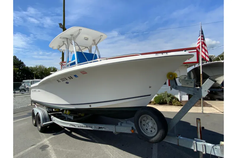 Slide: The Image of 2008 Sea Hunt Triton 220 boat on trailer, parked outdoors under blue sky. - 3