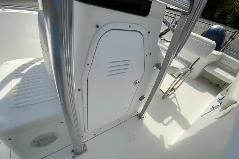 Slide: The Image of 2008 Sea Hunt Triton 220 boat interior with white seating and storage compartment. - 30