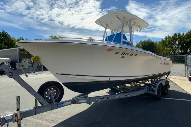 Slide: The Image of 2008 Sea Hunt Triton 220 boat on trailer under a partly cloudy sky. - 5