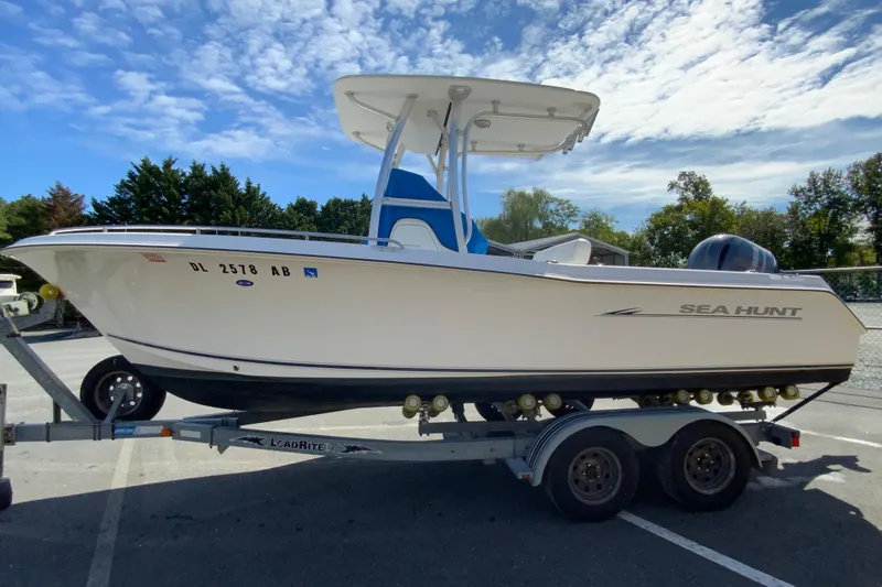 Slide: The Image of 2008 Sea Hunt Triton 220 boat on trailer under clear sky. - 6