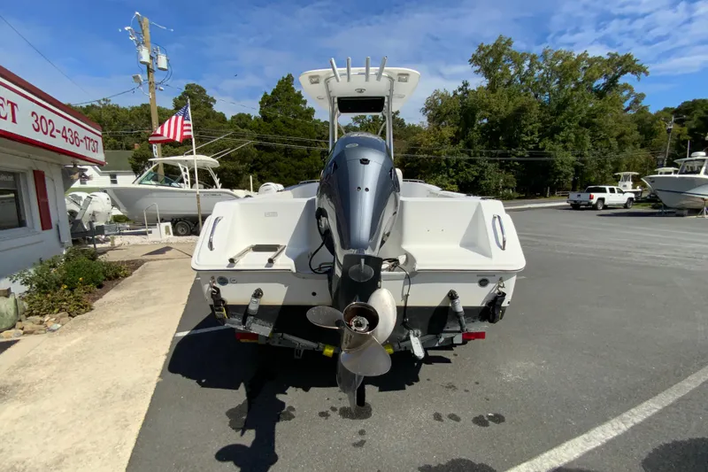 Slide: The Image of 2008 Sea Hunt Triton 220 boat with outboard motor in a parking lot. - 9