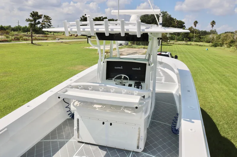 Slide: The Image of 2005 Venture 39 Open boat with Garmin electronics, set on a grassy field. - 12