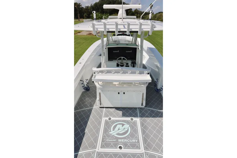 Slide: The Image of 2005 Venture 39 Open boat interior with Garmin console and Mercury branding. - 13