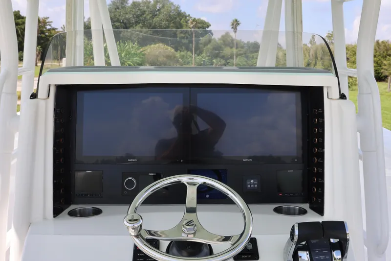 Slide: The Image of 2005 Venture 39 Open boat dashboard with dual screens and steering wheel. - 14