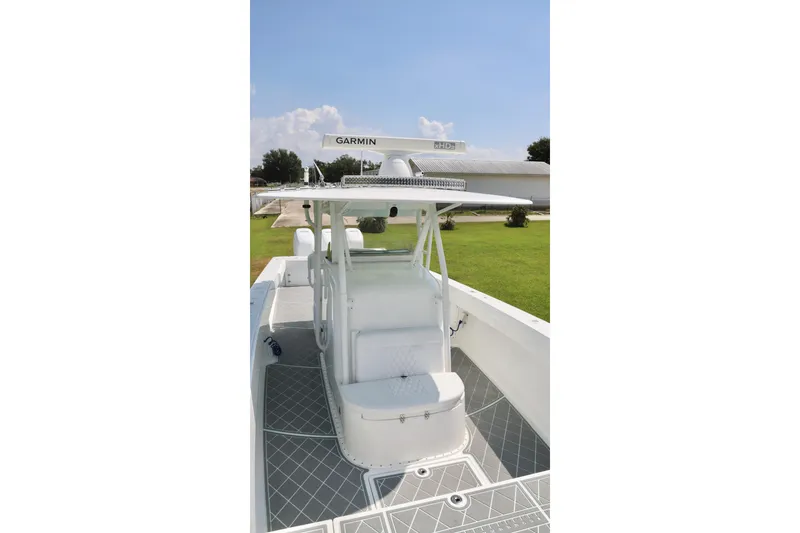 Slide: The Image of 2005 Venture 39 Open boat with Garmin equipment, featuring a sleek white deck and seating. - 9