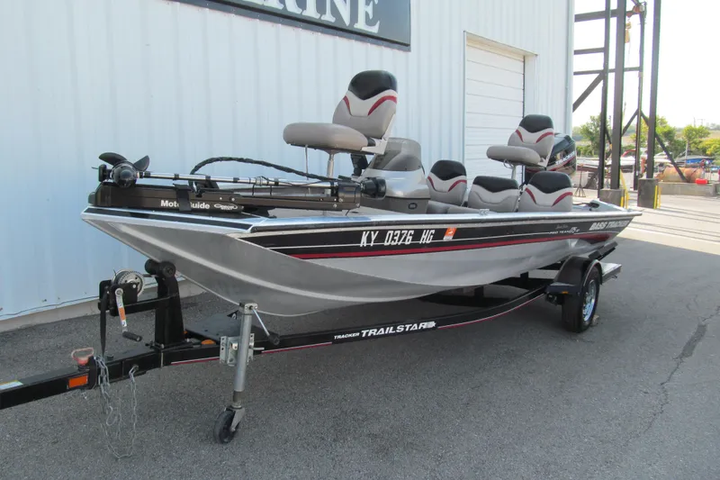 Slide: The Image of 2002 Tracker Pro Team 175 boat on trailer, parked outside a building. - 3