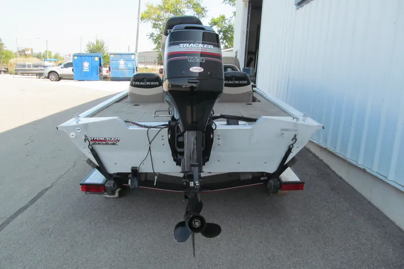 Slide: The Image of 2002 Tracker Pro Team 175 boat with outboard motor, parked on a trailer. - 4