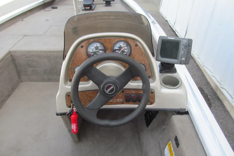 Slide: The Image of 2002 Tracker Pro Team 175 boat dashboard with steering wheel and gauges. - 6