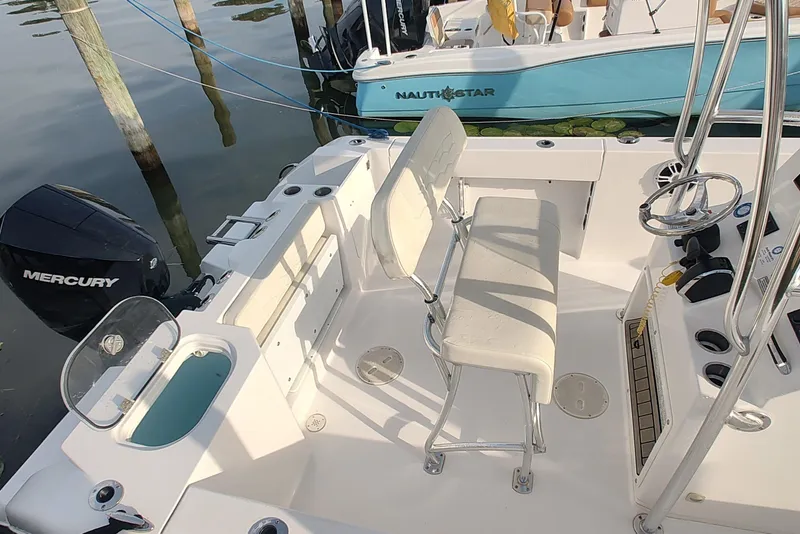 Slide: The Image of 2023 Twin Vee LFG 22 CC boat interior with seating and Mercury engine. - 5