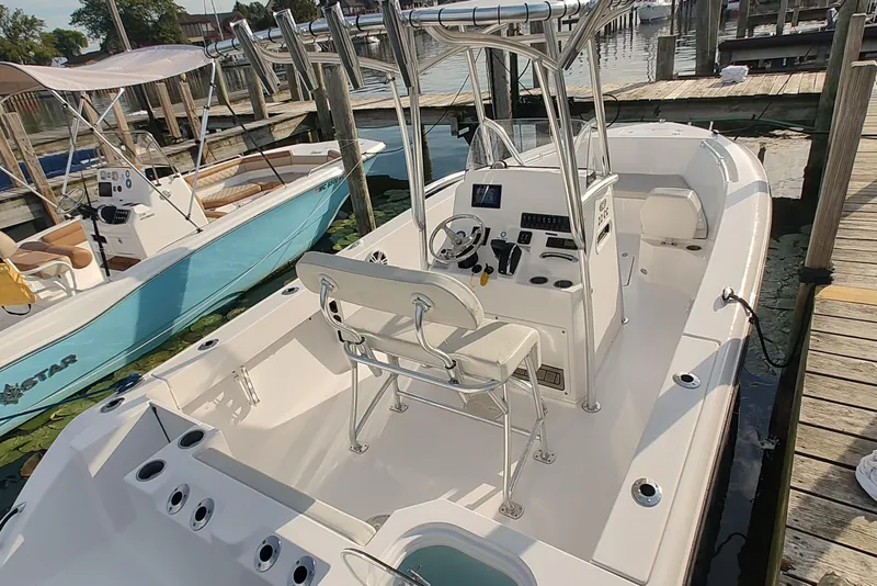 Slide: The Image of 2023 Twin Vee LFG 22 CC boat docked, featuring a sleek center console design. - 7