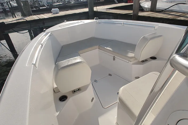 Slide: The Image of 2023 Twin Vee LFG 22 CC boat interior with cushioned seating and storage compartments. - 9