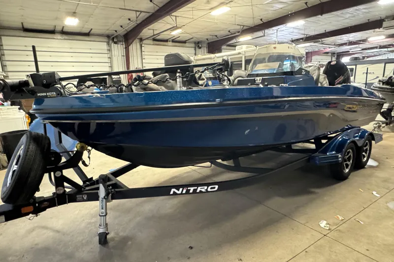 Slide: The Image of 2020 Nitro ZV20 Pro boat in a garage, blue exterior, on a trailer. - 1