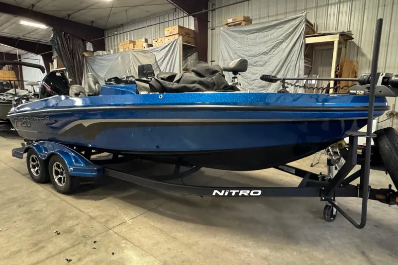 Slide: The Image of Blue 2020 Nitro ZV20 Pro boat on trailer in warehouse setting. - 2