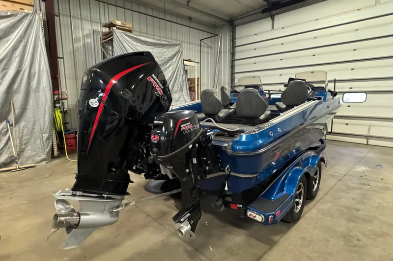 Slide: The Image of 2020 Nitro ZV20 Pro boat with powerful outboard motor in a garage setting. - 3