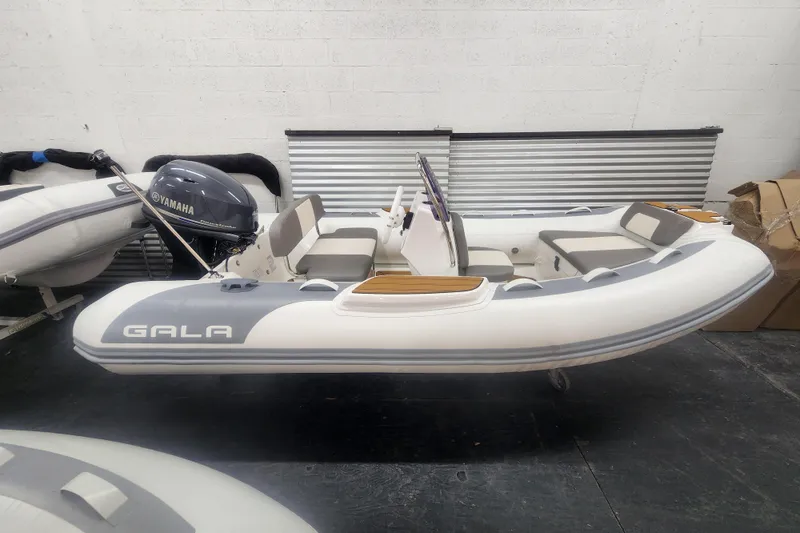 The Image of 2024 Gala A360L inflatable boat with Yamaha motor in a showroom setting. - 0
