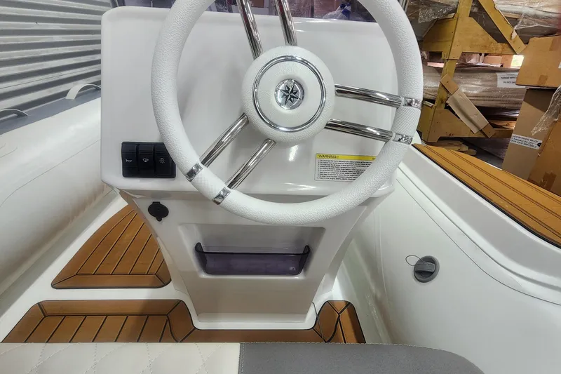 Slide: The Image of 2024 Gala A360L boat steering wheel with wooden deck accents. - 5
