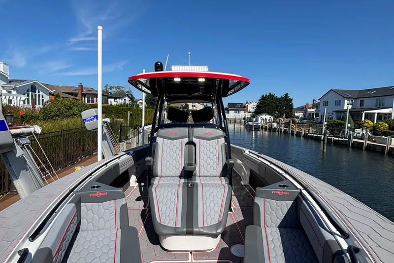 Slide: The Image of 2023 Fountain 34 SC boat docked in a scenic waterfront neighborhood. - 11